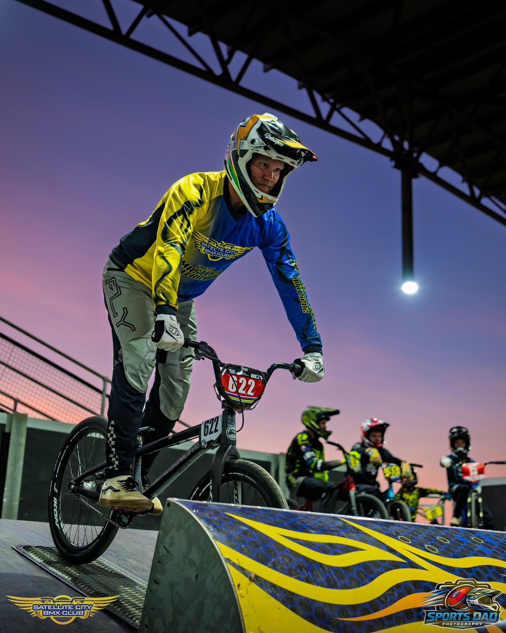 Adult rider in teal and pink Kaos Racing gear